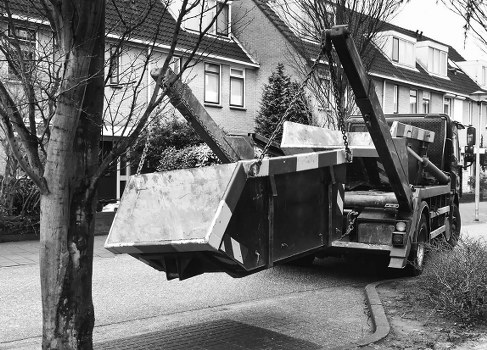 Pile of commercial waste and recycling bins mid-removal
